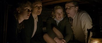 Movie still from “The Iron Lady” (2011), directed by Phyllida Lloyd – A group of people sitting next to each other in a room; Medium shot, High angle