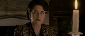 Movie still from “The Iron Lady” (2011), directed by Phyllida Lloyd – An older woman wearing a black and gold dress; Close Up shot, Low angle
