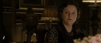 Movie still from “The Iron Lady” (2011), directed by Phyllida Lloyd – An older woman sitting in front of a lamp; Close Up shot, Over the shoulder angle
