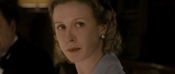 Movie still from “The Iron Lady” (2011), directed by Phyllida Lloyd – A person wearing a white shirt; Close Up shot, Low angle