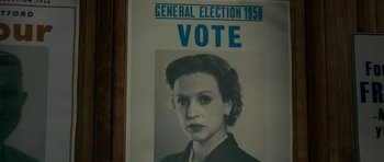Movie still from “The Iron Lady” (2011), directed by Phyllida Lloyd – An old photo of a woman with a vote sign on it; Extreme Close Up shot, High angle