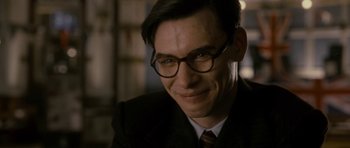 Movie still from “The Iron Lady” (2011), directed by Phyllida Lloyd – A person wearing glasses and a suit; Close Up shot, Over the shoulder angle