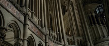 Movie still from “The Iron Lady” (2011), directed by Phyllida Lloyd – A very ornate looking building with many pillars and columns; Extreme Wide shot, Low angle