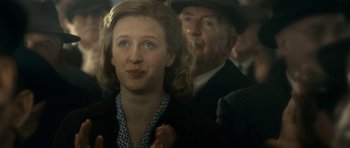 Movie still from “The Iron Lady” (2011), directed by Phyllida Lloyd – A woman and a man are standing together in a crowd; Close Up shot, Over the shoulder angle