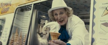 Movie still from “The Iron Lady” (2011), directed by Phyllida Lloyd – An older woman in a white hat holding an ice cream cone; Close Up shot, Over the shoulder angle