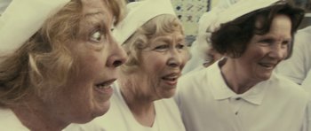 Movie still from “The Iron Lady” (2011), directed by Phyllida Lloyd – A group of women in white medical uniforms; Close Up shot, Low angle