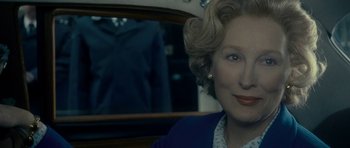 Movie still from “The Iron Lady” (2011), directed by Phyllida Lloyd – A person sitting in a car; Close Up shot, Over the shoulder angle