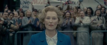 Movie still from “The Iron Lady” (2011), directed by Phyllida Lloyd – A person wearing a suit and tie; Close Up shot, Low angle