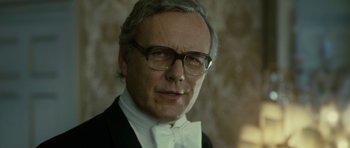 Movie still from “The Iron Lady” (2011), directed by Phyllida Lloyd – An older man in a suit and bow tie; Close Up shot, Low angle
