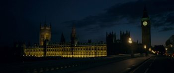Movie still from “The Iron Lady” (2011), directed by Phyllida Lloyd – A large building that is lit up at night; Extreme Wide shot, Low angle