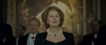 Movie still from “The Iron Lady” (2011), directed by Phyllida Lloyd – A person wearing a necklace; Close Up shot, Low angle