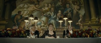 Movie still from “The Iron Lady” (2011), directed by Phyllida Lloyd – A group of people sitting at a dinner table; Wide shot, High angle