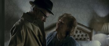 Movie still from “The Iron Lady” (2011), directed by Phyllida Lloyd – An older man standing next to an older woman; Close Up shot, Over the shoulder angle