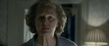 Movie still from “The Iron Lady” (2011), directed by Phyllida Lloyd – An older woman with a sad look on her face; Close Up shot, Over the shoulder angle