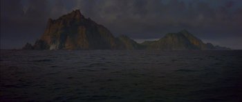 Movie still from “The Island” (1980), directed by Michael Ritchie – A view of a body of water with mountains in the background; Extreme Wide shot, High angle