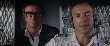 Movie still from “The Island” (1980), directed by Michael Ritchie – A man in a suit sitting next to another man in a white shirt; Close Up shot, Low angle