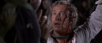 Movie still from “The Island” (1980), directed by Michael Ritchie – A person with blood all over his face; Close Up shot, Over the shoulder angle