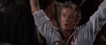 Movie still from “The Island” (1980), directed by Michael Ritchie – A person with blood on his face; Close Up shot, High angle