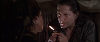 Movie still from “The Island” (1980), directed by Michael Ritchie – A man lighting a cigarette in front of a woman; Close Up shot, Over the shoulder angle