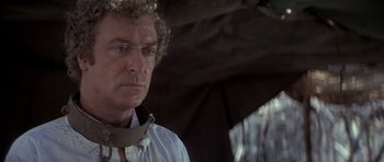 Movie still from “The Island” (1980), directed by Michael Ritchie – A person wearing a shirt and tie; Close Up shot, Over the shoulder angle