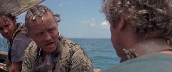 Movie still from “The Island” (1980), directed by Michael Ritchie – Two people sitting on a boat in the water; Close Up shot, Over the shoulder angle