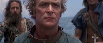 Movie still from “The Island” (1980), directed by Michael Ritchie – A person wearing a neck brace; Close Up shot, Over the shoulder angle