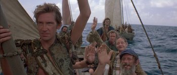Movie still from “The Island” (1980), directed by Michael Ritchie – A group of people on a boat in the water; Medium shot, Low angle