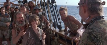 Movie still from “The Island” (1980), directed by Michael Ritchie – A group of people standing on top of a boat; Medium shot, Over the shoulder angle