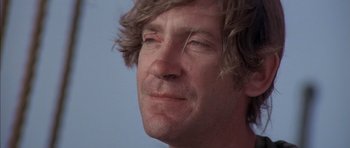 Movie still from “The Island” (1980), directed by Michael Ritchie – A person's face with long hair; Close Up shot, Low angle
