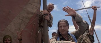 Movie still from “The Island” (1980), directed by Michael Ritchie – A group of people standing next to each other on top of a pole; Medium shot, Low angle