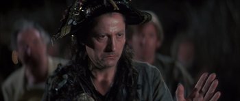 Movie still from “The Island” (1980), directed by Michael Ritchie – A person wearing a pirate hat; Close Up shot, Over the shoulder angle