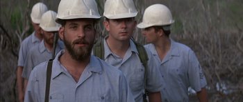 Movie still from “The Island” (1980), directed by Michael Ritchie – A group of construction workers wearing hard hats; Close Up shot, Low angle