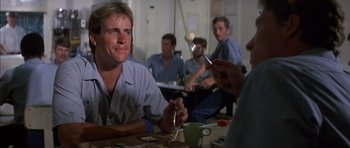 Movie still from “The Island” (1980), directed by Michael Ritchie – A group of people sitting at a table eating food; Close Up shot, Over the shoulder angle