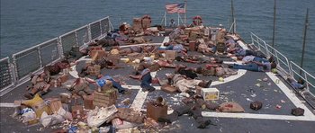 Movie still from “The Island” (1980), directed by Michael Ritchie – A group of people laying on the deck of a boat; Extreme Wide shot, High angle