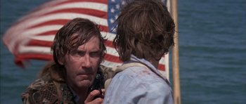 Movie still from “The Island” (1980), directed by Michael Ritchie – A man is looking at himself in the mirror; Close Up shot, Over the shoulder angle