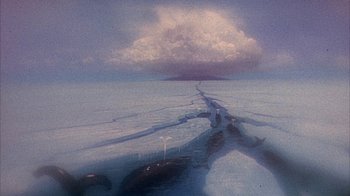 Movie still from “The Island at the Top of the World” (1974), directed by Robert Stevenson – A view of a body of water and a cloud in the sky; Extreme Wide shot, High angle