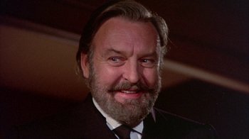 Movie still from “The Island at the Top of the World” (1974), directed by Robert Stevenson – A person wearing a suit and tie; Close Up shot, Low angle