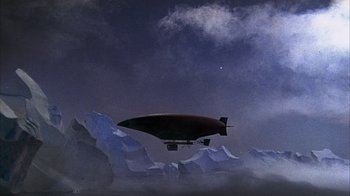 Movie still from “The Island at the Top of the World” (1974), directed by Robert Stevenson – An airship is flying over a mountain range; Extreme Wide shot, Low angle