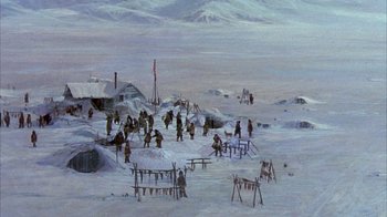 Movie still from “The Island at the Top of the World” (1974), directed by Robert Stevenson – An oil painting of a group of people standing in the middle of a snow covered field; Extreme Wide shot, High angle