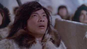 Movie still from “The Island at the Top of the World” (1974), directed by Robert Stevenson – A man wearing a fur coat looking up at the sky; Close Up shot, Low angle