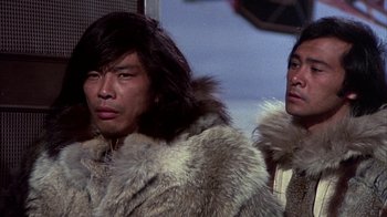 Movie still from “The Island at the Top of the World” (1974), directed by Robert Stevenson – Two men in fur coats standing next to each other; Close Up shot, Low angle