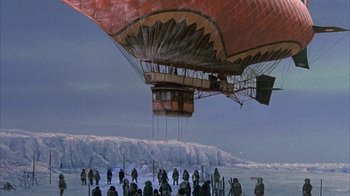 Movie still from “The Island at the Top of the World” (1974), directed by Robert Stevenson – A group of people standing around a hot air balloon; Extreme Wide shot, High angle