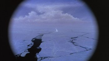 Movie still from “The Island at the Top of the World” (1974), directed by Robert Stevenson – A view of a body of water and a cloud in the sky; Extreme Wide shot, Overhead angle