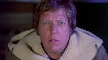 Movie still from “The Island at the Top of the World” (1974), directed by Robert Stevenson – A person wearing a blanket; Close Up shot, Low angle