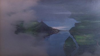 Movie still from “The Island at the Top of the World” (1974), directed by Robert Stevenson – A painting of a river with a castle in the background; Extreme Wide shot, Overhead angle