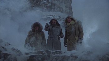 Movie still from “The Island at the Top of the World” (1974), directed by Robert Stevenson – A group of people standing next to each other in the snow; Wide shot, Low angle