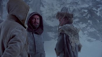 Movie still from “The Island at the Top of the World” (1974), directed by Robert Stevenson – Two men in medieval garb standing next to each other; Medium shot, Over the shoulder angle
