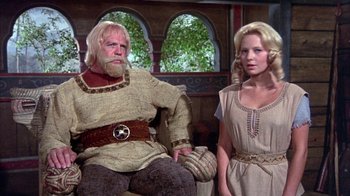 Movie still from “The Island at the Top of the World” (1974), directed by Robert Stevenson – A man and a woman standing next to each other; Medium shot, Low angle