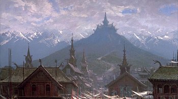 Movie still from “The Island at the Top of the World” (1974), directed by Robert Stevenson – A painting of a town with mountains in the background; Extreme Wide shot, Low angle