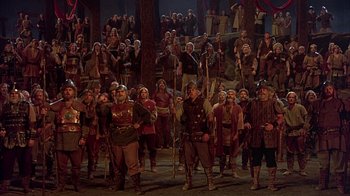 Movie still from “The Island at the Top of the World” (1974), directed by Robert Stevenson – A group of people dressed in medieval clothing; Wide shot, High angle